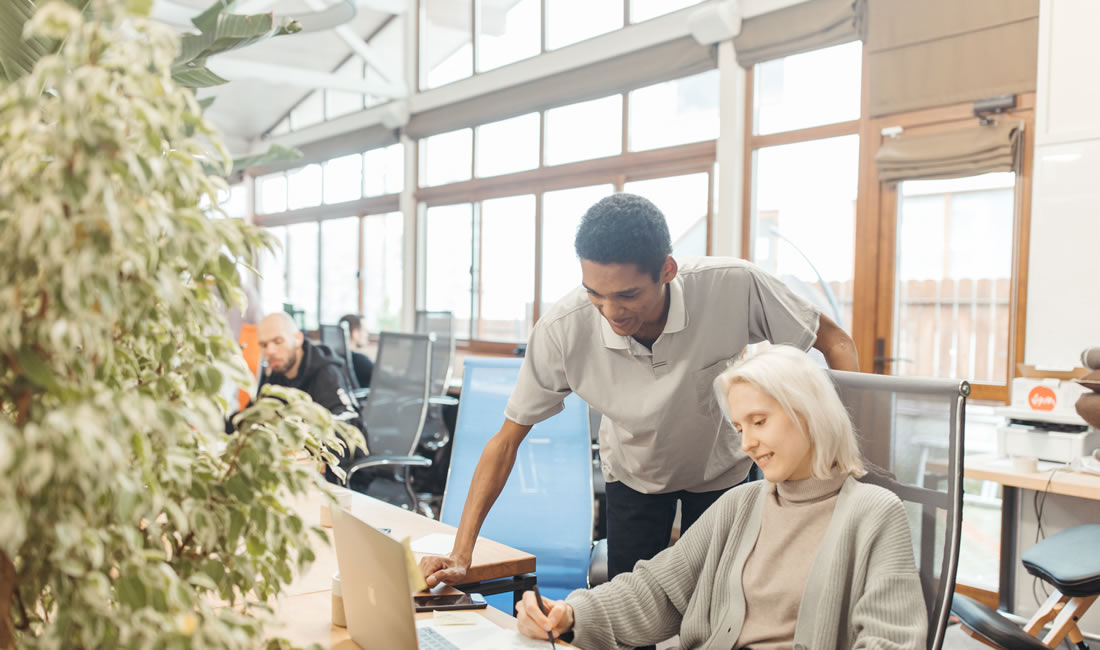Diverse team collaborating in a modern office space, working together around a shared table